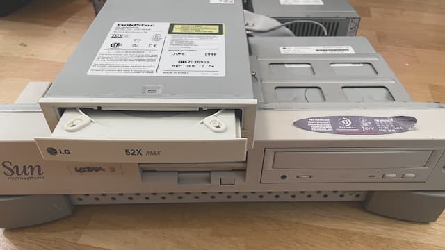 Photo of open workstation, Old CD-ROM with newer and aged faceplate, and new CD-ROM with old faceplate..