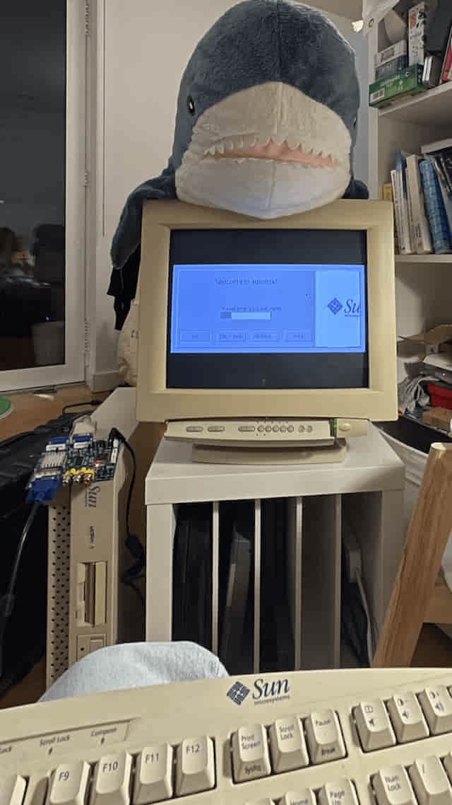 A photo of an XDM displaying login prompt from the Sun workstation on a CRT monitor via sync adapter. A plushie sits on top.